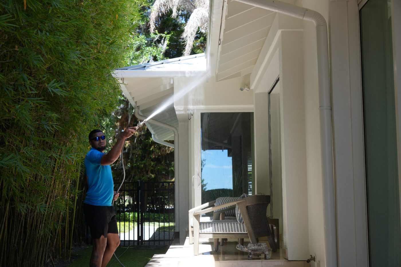 Hand cleaning house siding with a brush